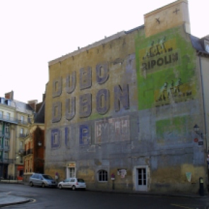 Old 1920s advertising on a building in Rennes, France