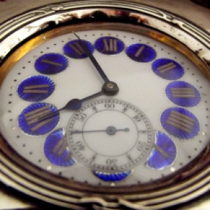 This blue and white enameled silver watch sits in a my bookcase.