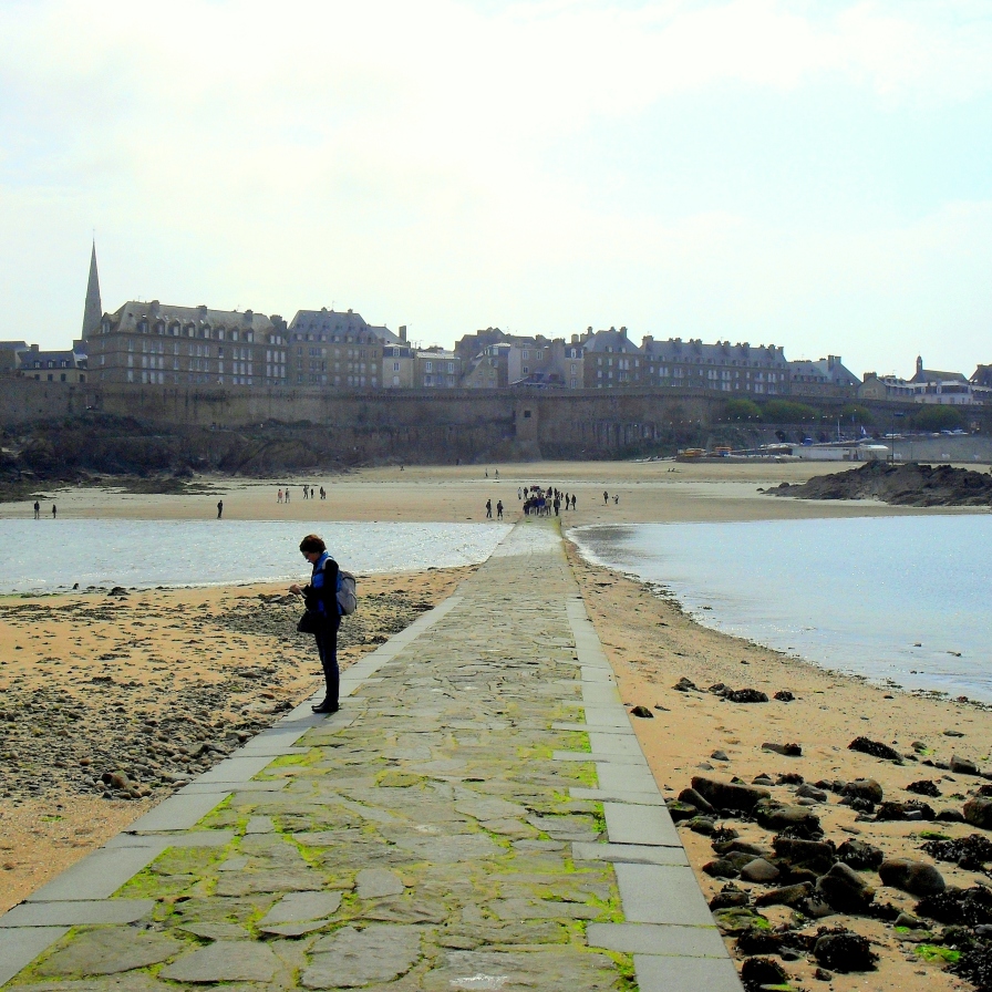 St Malo in the distance while the tide rushes in to trap the unwary traveler lingering at Chateaubriand's tomb. https://amaviedecoeurentier.wordpress.com/2015/03/03/rebel-without-a-causeway/