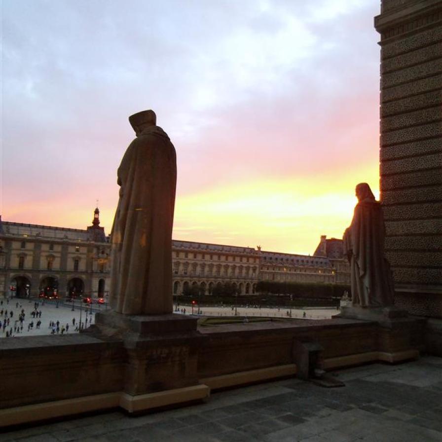 I gazed through the window of the Louvre as the sun set.