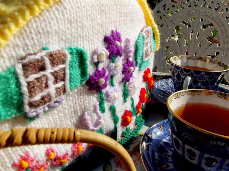 This knitted tea cosy keeps the pot warm in the garden on this crisp spring morning
